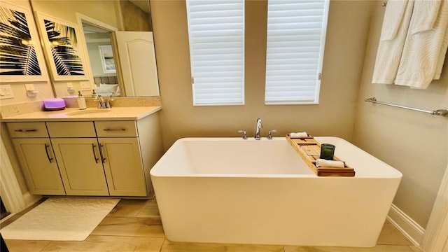 bathroom featuring vanity and a washtub