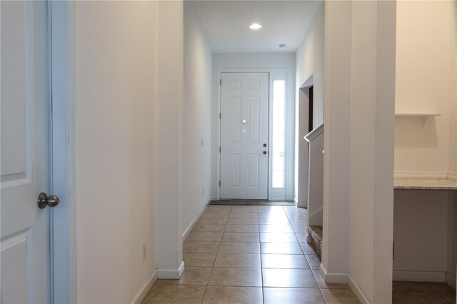 doorway to outside with light tile patterned floors