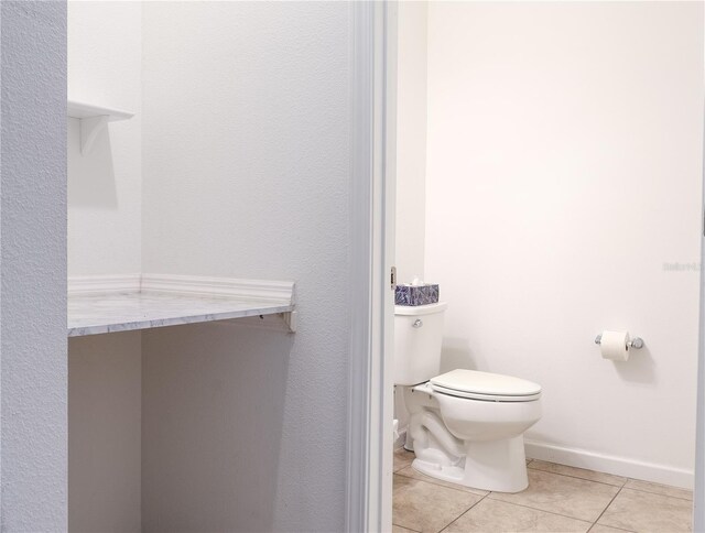 bathroom with tile patterned flooring and toilet