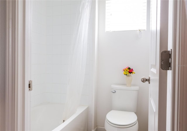 bathroom with shower / bath combo and toilet