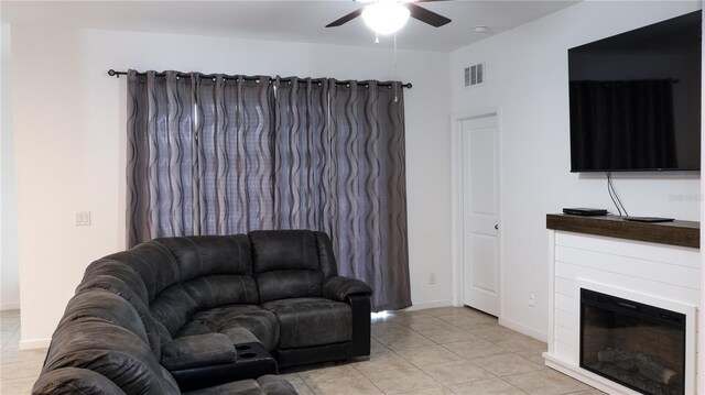 tiled living room featuring ceiling fan