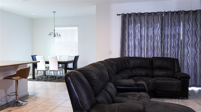 tiled living room with a chandelier