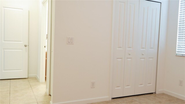 hallway featuring light tile patterned floors