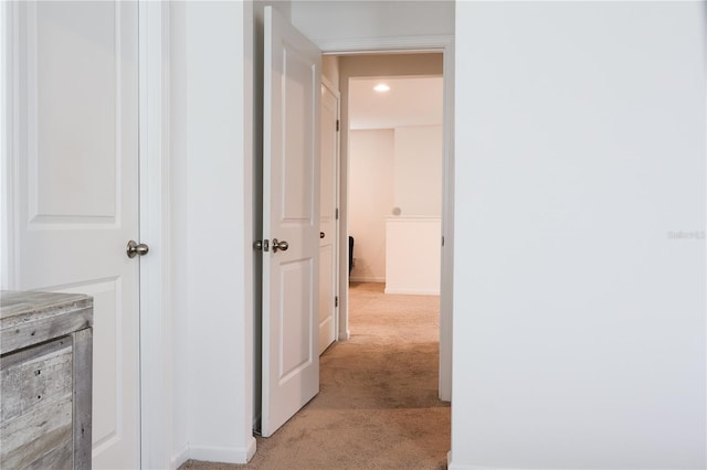 hallway with light colored carpet