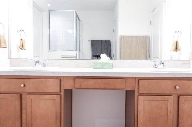 bathroom featuring walk in shower and vanity