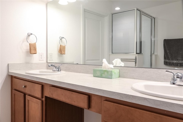 bathroom with walk in shower and vanity