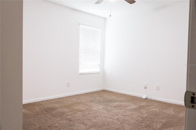 spare room with carpet flooring and ceiling fan