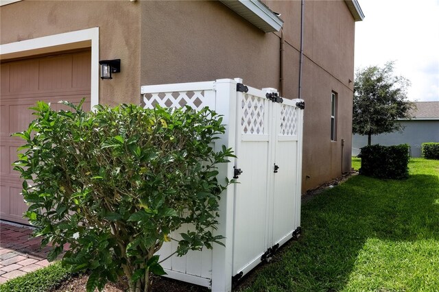 view of side of home with a yard