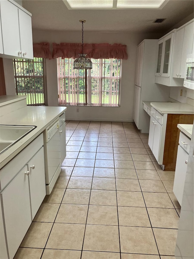 kitchen featuring light tile patterned floors, white appliances, decorative light fixtures, and white cabinetry