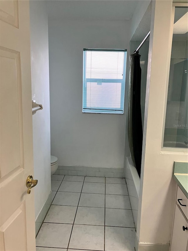 full bathroom with tile patterned floors, vanity, toilet, and shower / tub combo