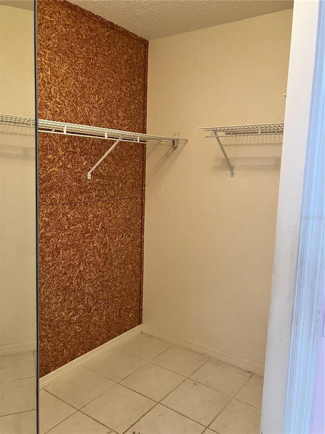 spacious closet featuring tile patterned floors