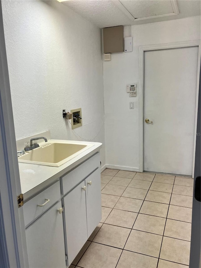 bathroom featuring tile patterned flooring, vanity, and a textured ceiling