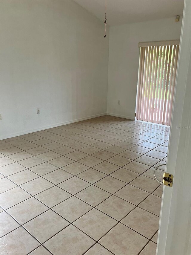 spare room featuring light tile patterned floors