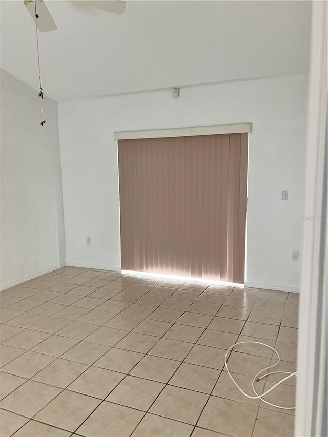 tiled empty room with ceiling fan