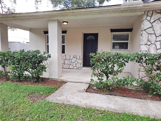 doorway to property featuring covered porch