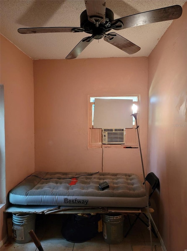 bedroom featuring a textured ceiling, ceiling fan, and cooling unit