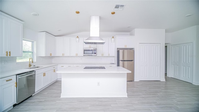 kitchen with a center island, stainless steel appliances, sink, and pendant lighting