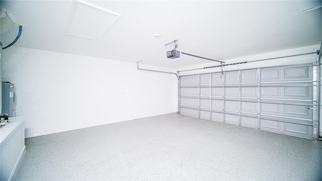 garage with concrete block wall and a garage door opener