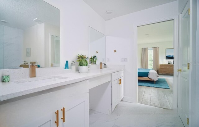 bathroom with a textured ceiling and vanity