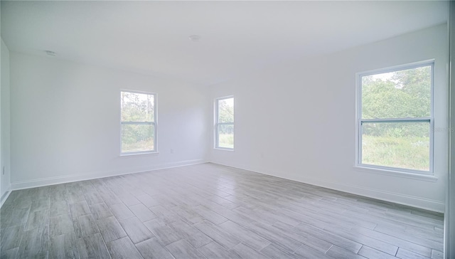 unfurnished room with light wood-type flooring