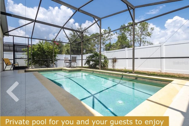 view of swimming pool featuring a patio area and glass enclosure