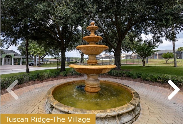 view of property's community with a lawn