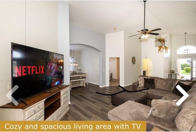 living room with dark hardwood / wood-style floors, high vaulted ceiling, and ceiling fan with notable chandelier