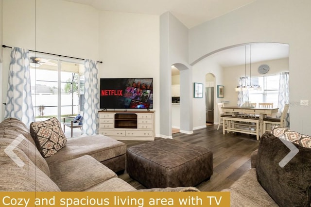 living room featuring ceiling fan, high vaulted ceiling, and dark hardwood / wood-style flooring