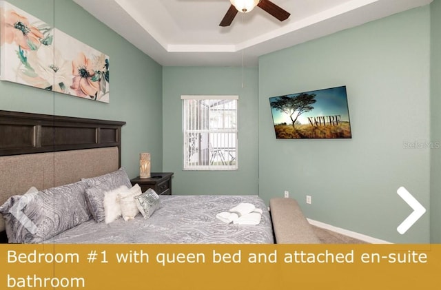 bedroom featuring a tray ceiling and ceiling fan