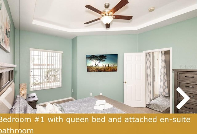 unfurnished bedroom with a tray ceiling and ceiling fan