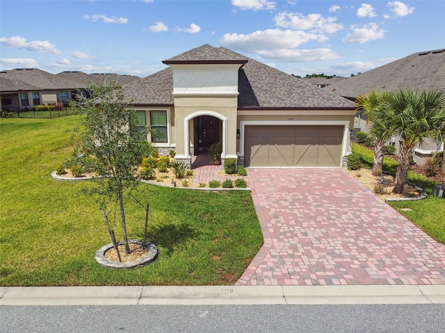 view of front facade with a front yard and a garage