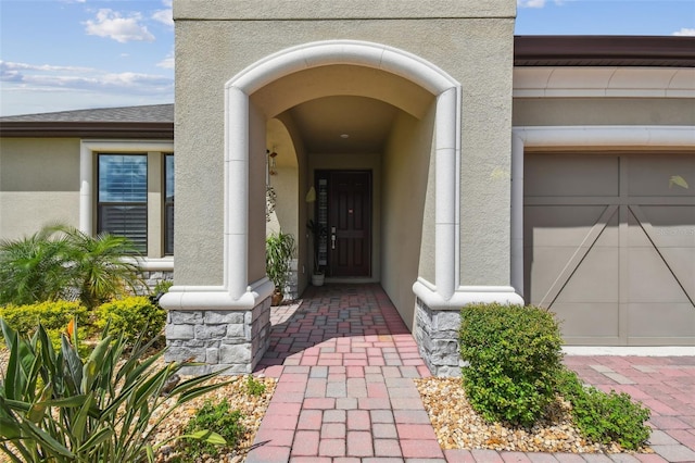 view of exterior entry featuring a garage