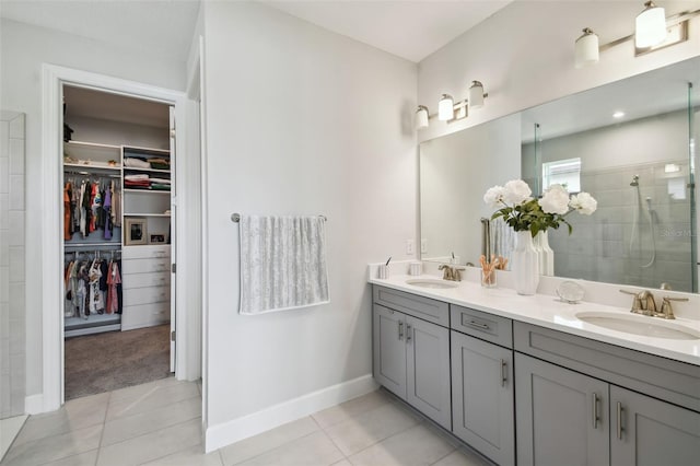 bathroom with tile patterned flooring, a shower with door, and vanity