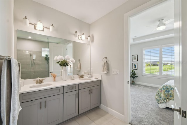 bathroom featuring a shower with door, vanity, ceiling fan, and tile patterned flooring