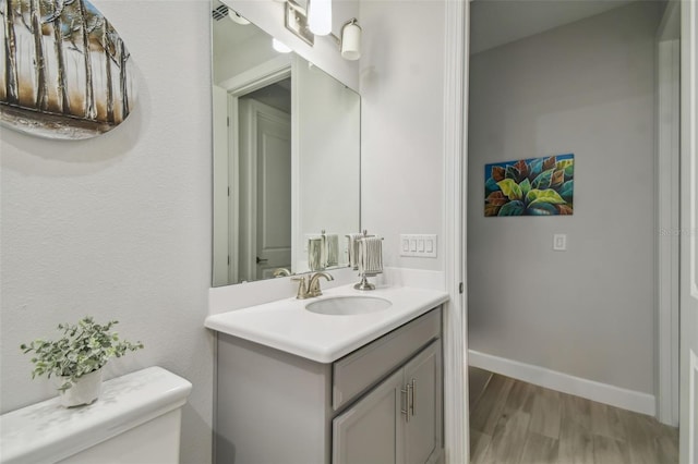 bathroom featuring hardwood / wood-style floors, toilet, and vanity