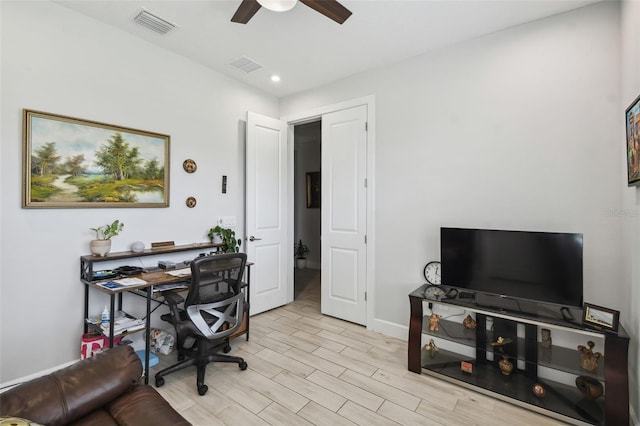 home office featuring light wood-type flooring and ceiling fan