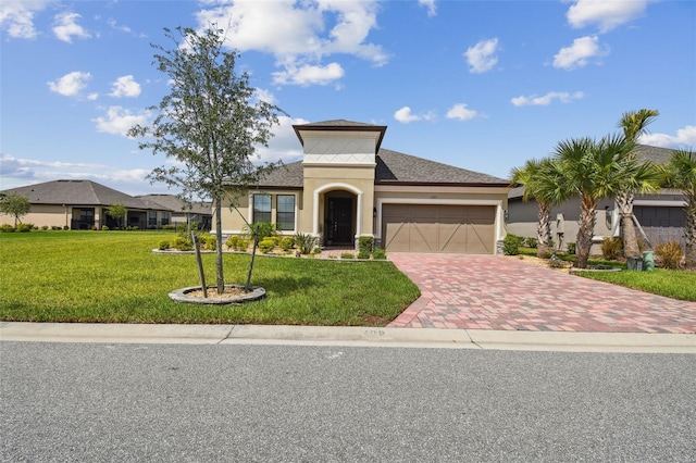 view of front of property with a garage and a front lawn