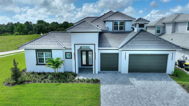 view of front of home with a garage and a front lawn