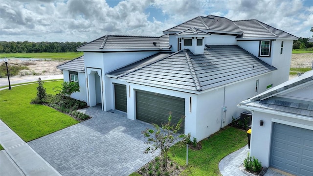 view of front of property with a garage and a front lawn