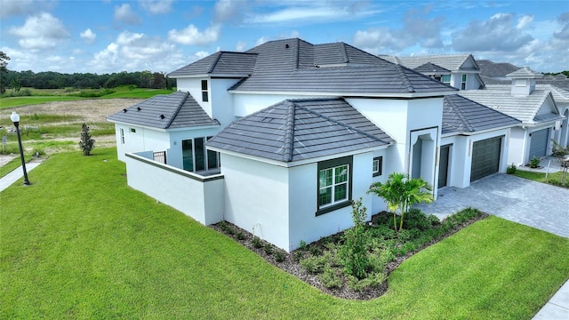 back of property featuring a yard and a garage