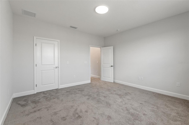 unfurnished bedroom featuring light carpet