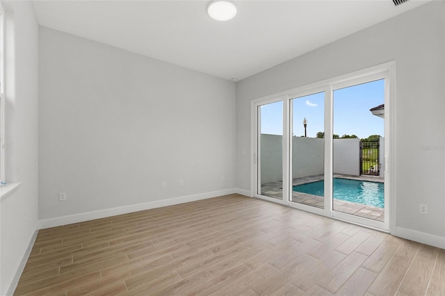 unfurnished room with light wood-type flooring