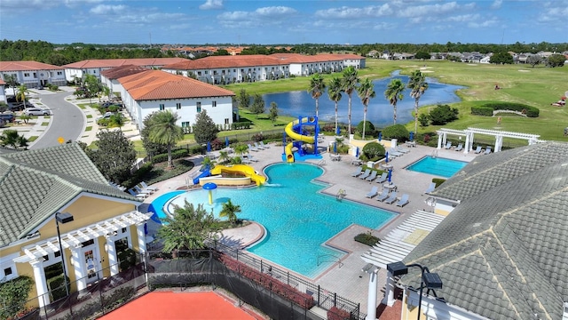 view of pool with a water view, a water slide, a pergola, and a patio