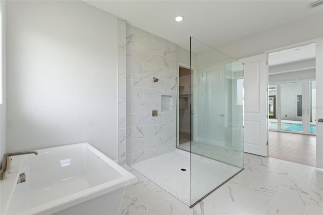 107 Hampton Loop, Davenport, FL 33837 - full bathroom with marble finish floors, a soaking tub, walk in shower, recessed lighting, and a sink