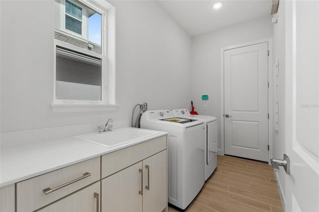 107 Hampton Loop, Davenport, FL 33837 - clothes washing area with separate washer and dryer, light wood-style flooring, cabinet space, and recessed lighting