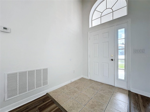 entryway featuring light tile patterned floors, visible vents, and baseboards