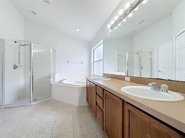 full bath with a sink, lofted ceiling, a garden tub, and a stall shower