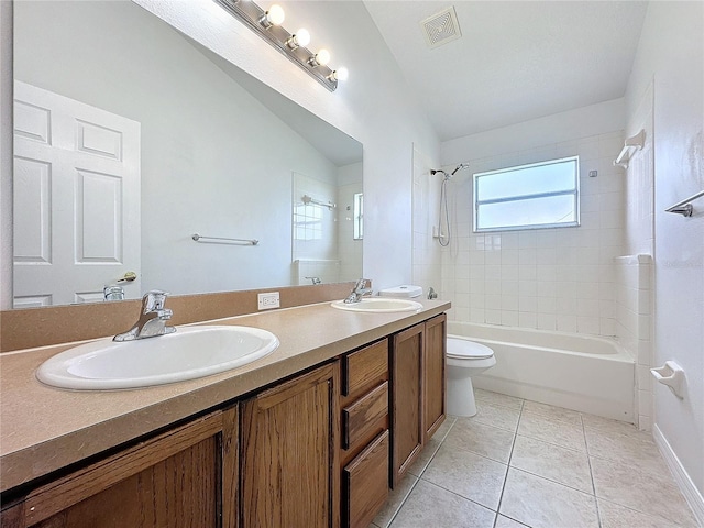 bathroom featuring tile patterned flooring, visible vents, toilet, and a sink