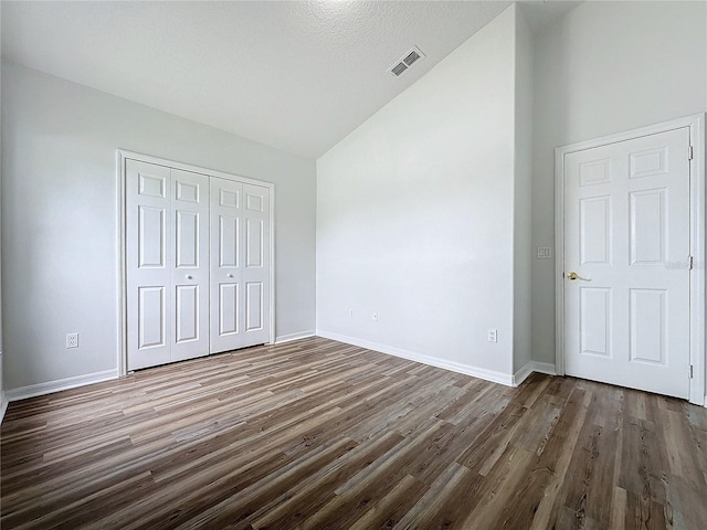 unfurnished bedroom featuring visible vents, baseboards, and dark wood-type flooring