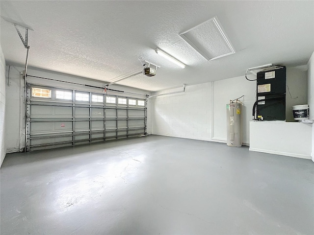 garage featuring heating unit, concrete block wall, a garage door opener, and water heater